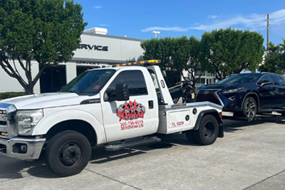 AER Towing Miami Jumpstart Service Tow Truck Towing a Car