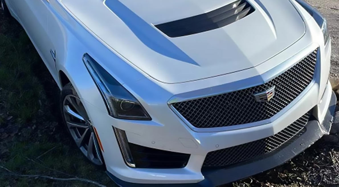 AER Towing Miami Jumpstart Service White Cadillac getting pulled out of ditch